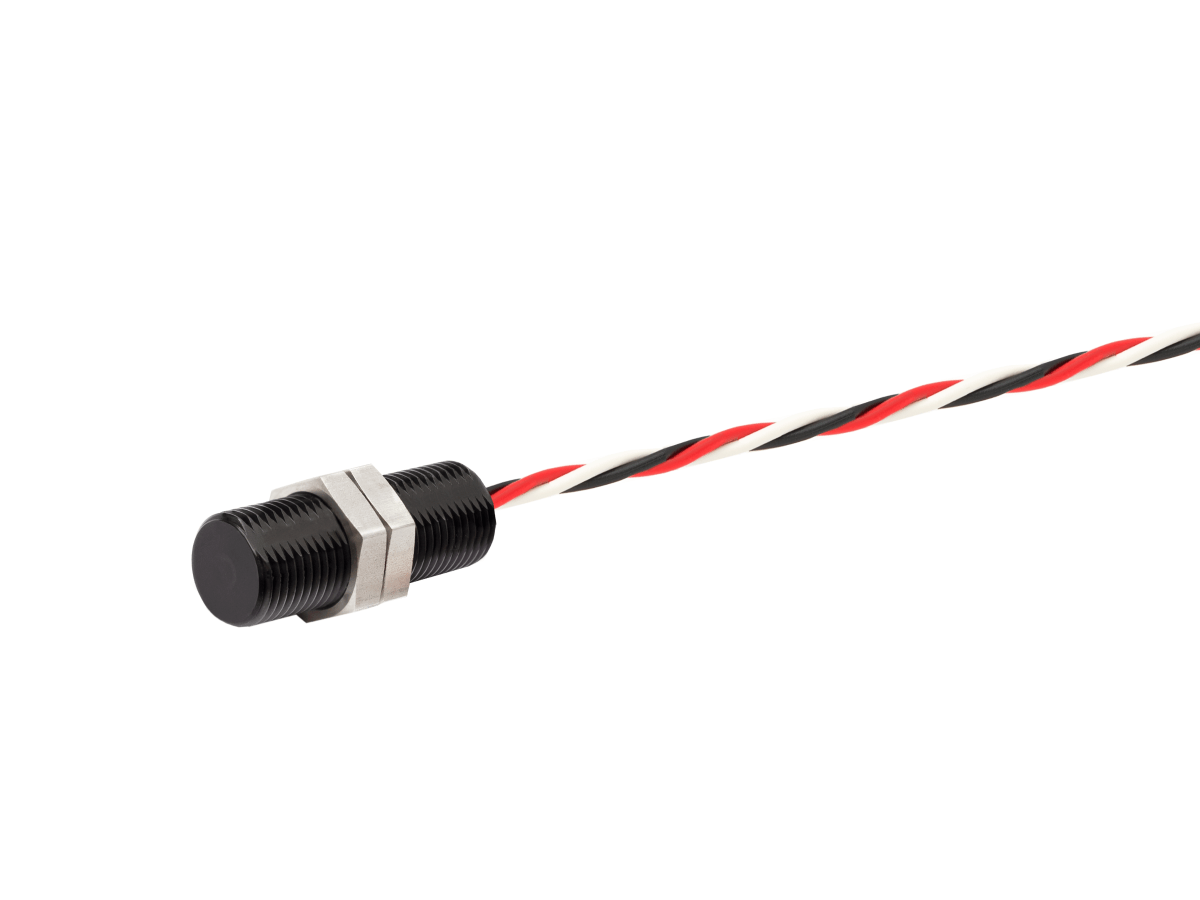 A cylindrical black angle position sensor from the APS Series with a hexagonal metal nut, attached to a twisted pair of red, black, and white wires, on a white background. by Standex Detect