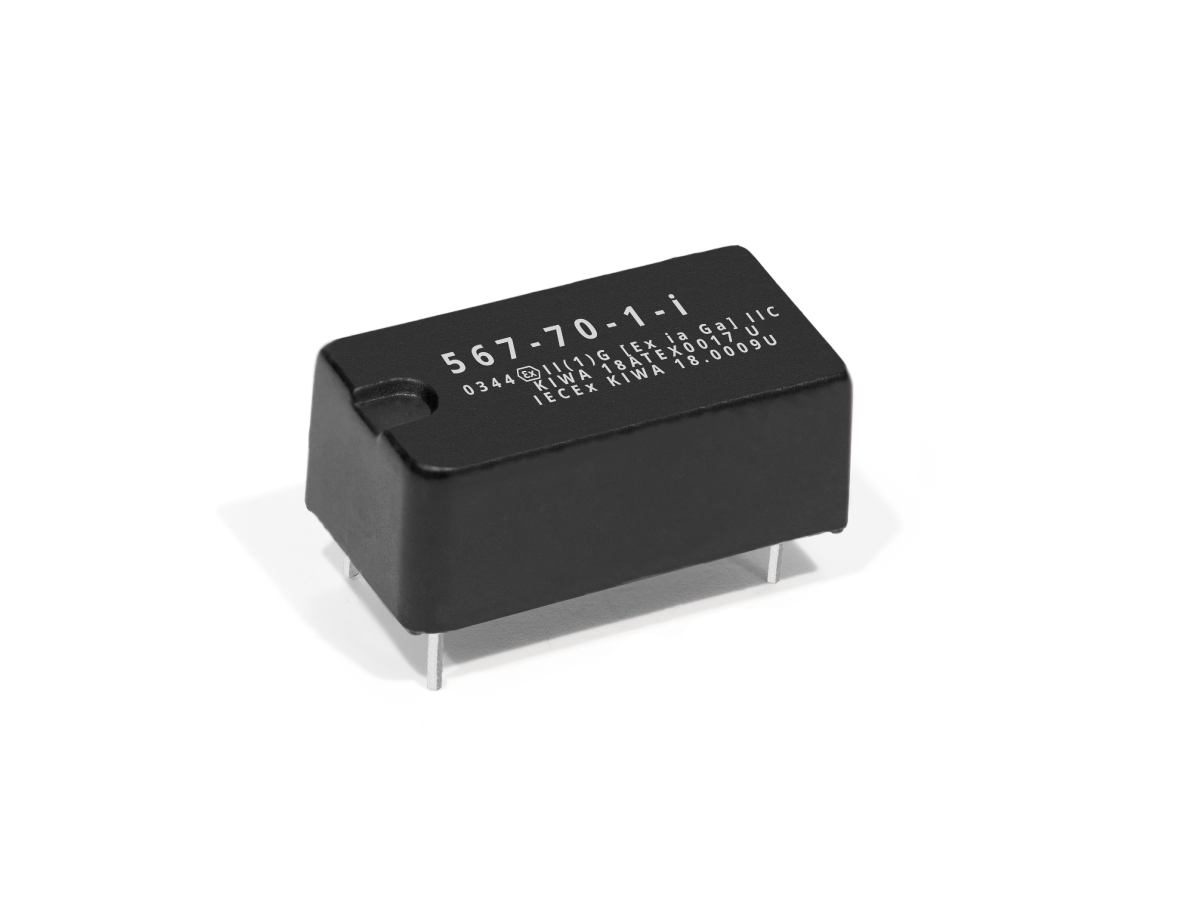 A black rectangular 567 Series Optocouplers component with metal pins protruding from the bottom, featuring white alphanumeric markings on its top surface, is placed on a plain white background. by Standex Detect