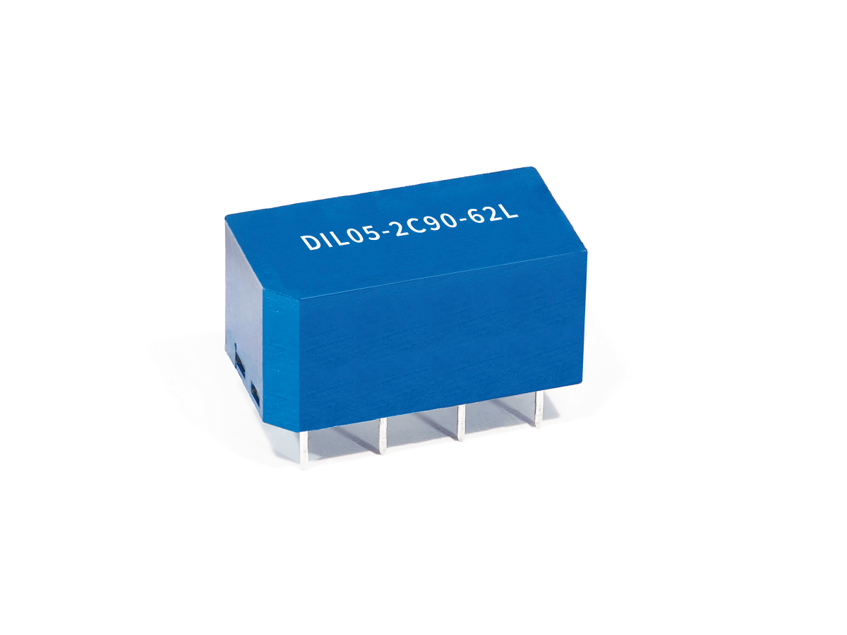 A blue rectangular Reed Relay from the DIL Series with five metal pins and the label DIL05-2C90-62L printed on top, shown against a white background. by Standex Detect