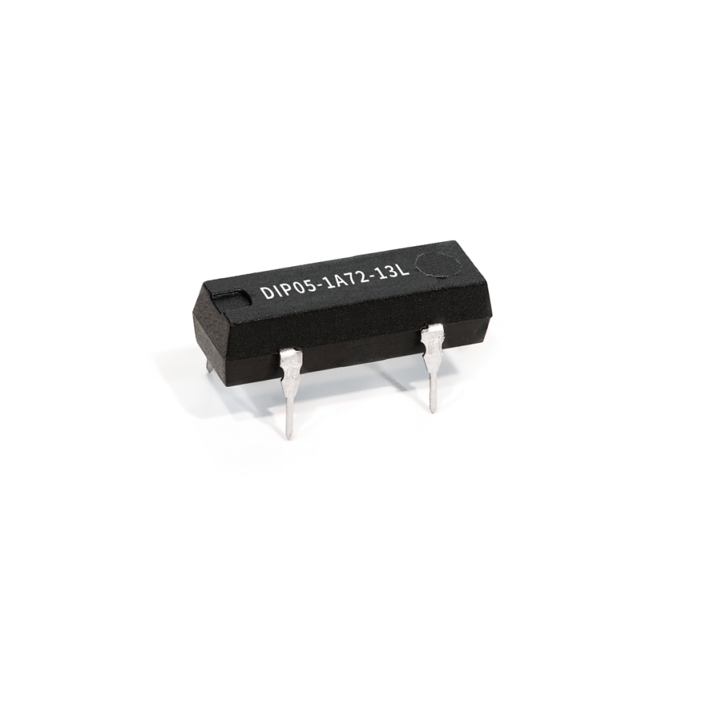 A small black integrated circuit Reed Relay with four metal pins, labeled DIP05-1A72-13L from the DIP Series, set against a plain white background. by Standex Detect
