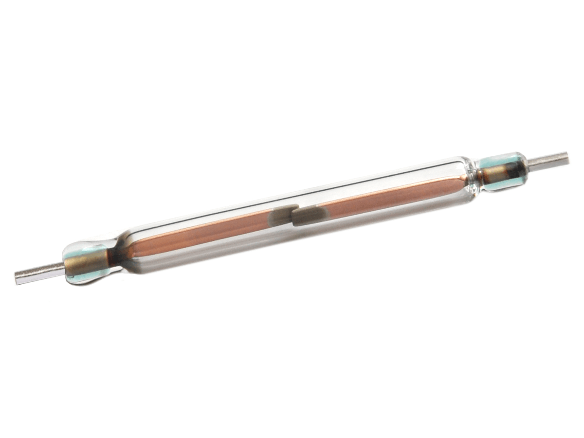 A close-up of a KSK-1A54 Series reed switch with metal leads at both ends, showing the thin internal contacts and a copper coil inside the transparent tube. by Standex Detect