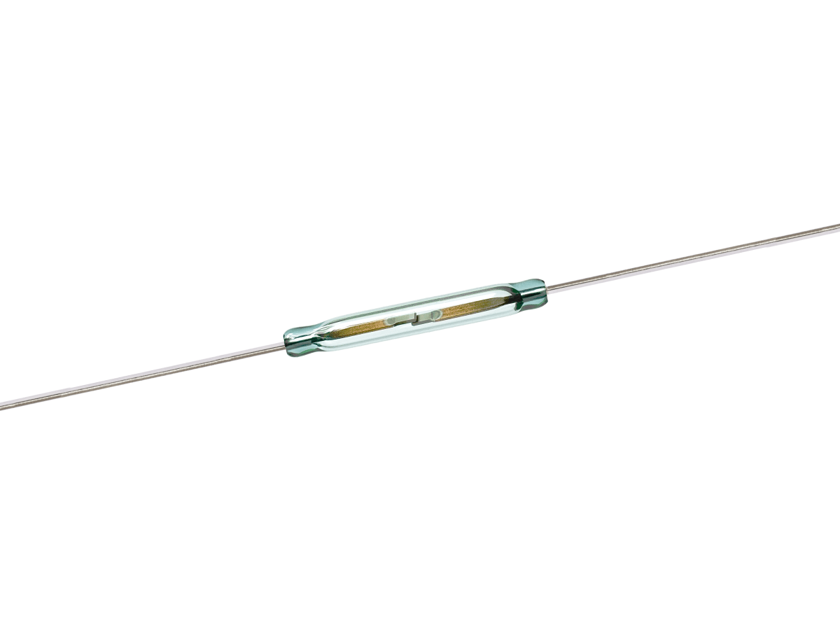 A close-up of a glass Reed Switch from the ORD2210V Series, featuring two long metal wires extending from each end, used for detecting magnetic fields in electronic circuits. by Standex Detect