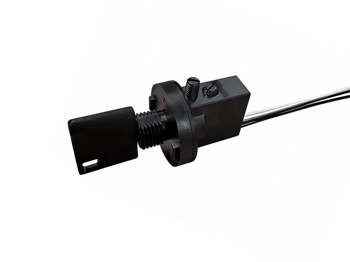 Close-up of a black KS01 Series industrial sensor or switch with a rectangular actuator, threaded mounting, and attached wires on a white background—perfect for precise reed sensor or key switch applications. by Standex Detect