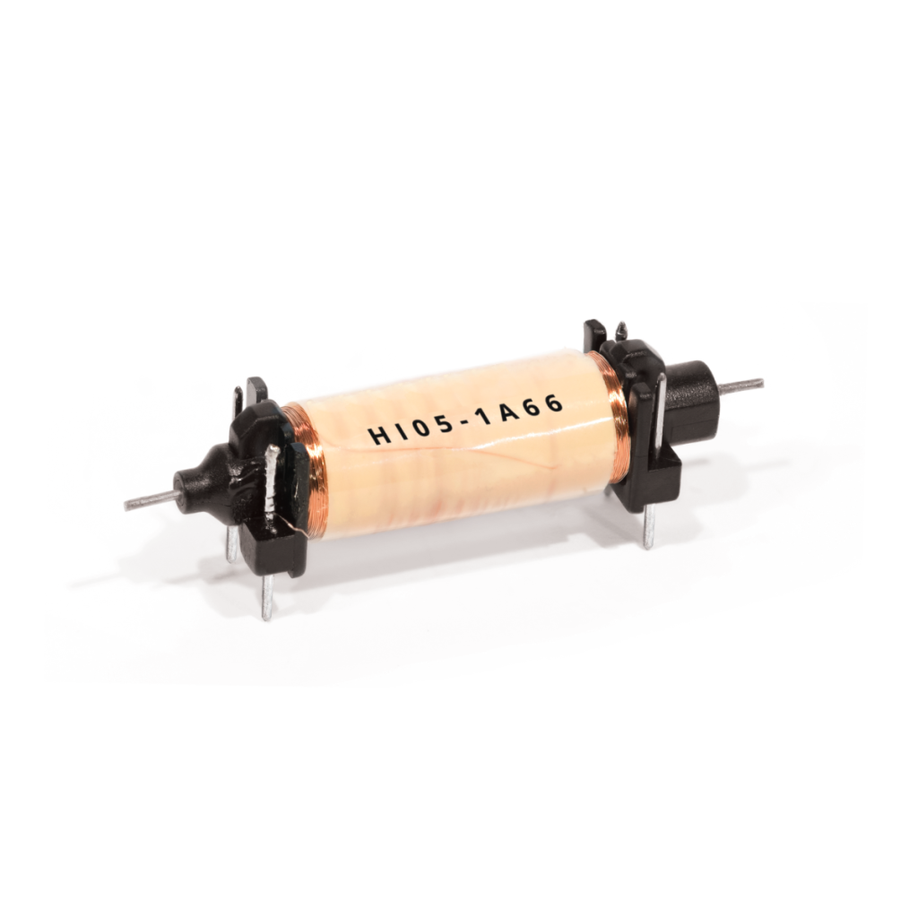 A cylindrical electronic component with copper wire wound around a light-colored core, mounted on a black plastic base with metal pins—resembling those found in Reed Relays—and labeled H105-1A66. by Standex Detect