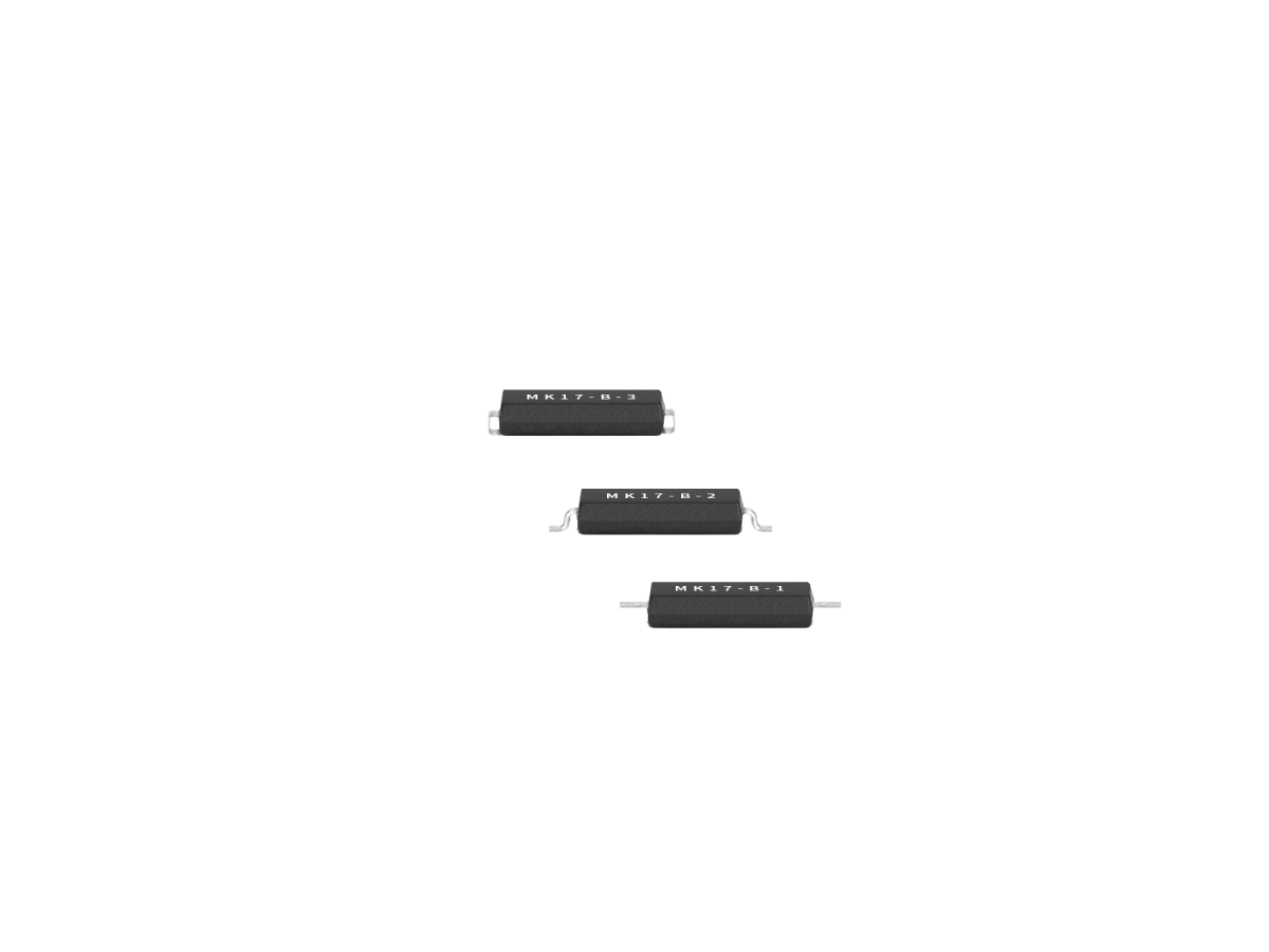 Three small black rectangular Surface Mount Reed Switch components from the MK17 Series, labeled “MR17-B-2,” are arranged in a diagonal line on a white background. Each component has metal leads on both sides. by Standex Detect