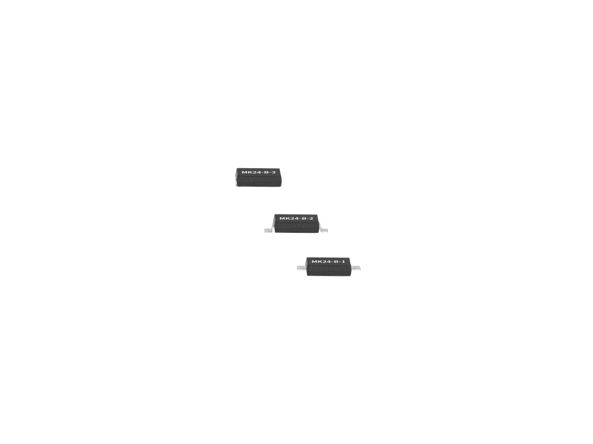 Three small, black, rectangular electronic components from the MK24 Series, featuring metallic connectors on both sides, are arranged vertically against a white background. Each Surface Mount Reed Switch is labeled “MM3Z4.3-B R1.”. by Standex Detect