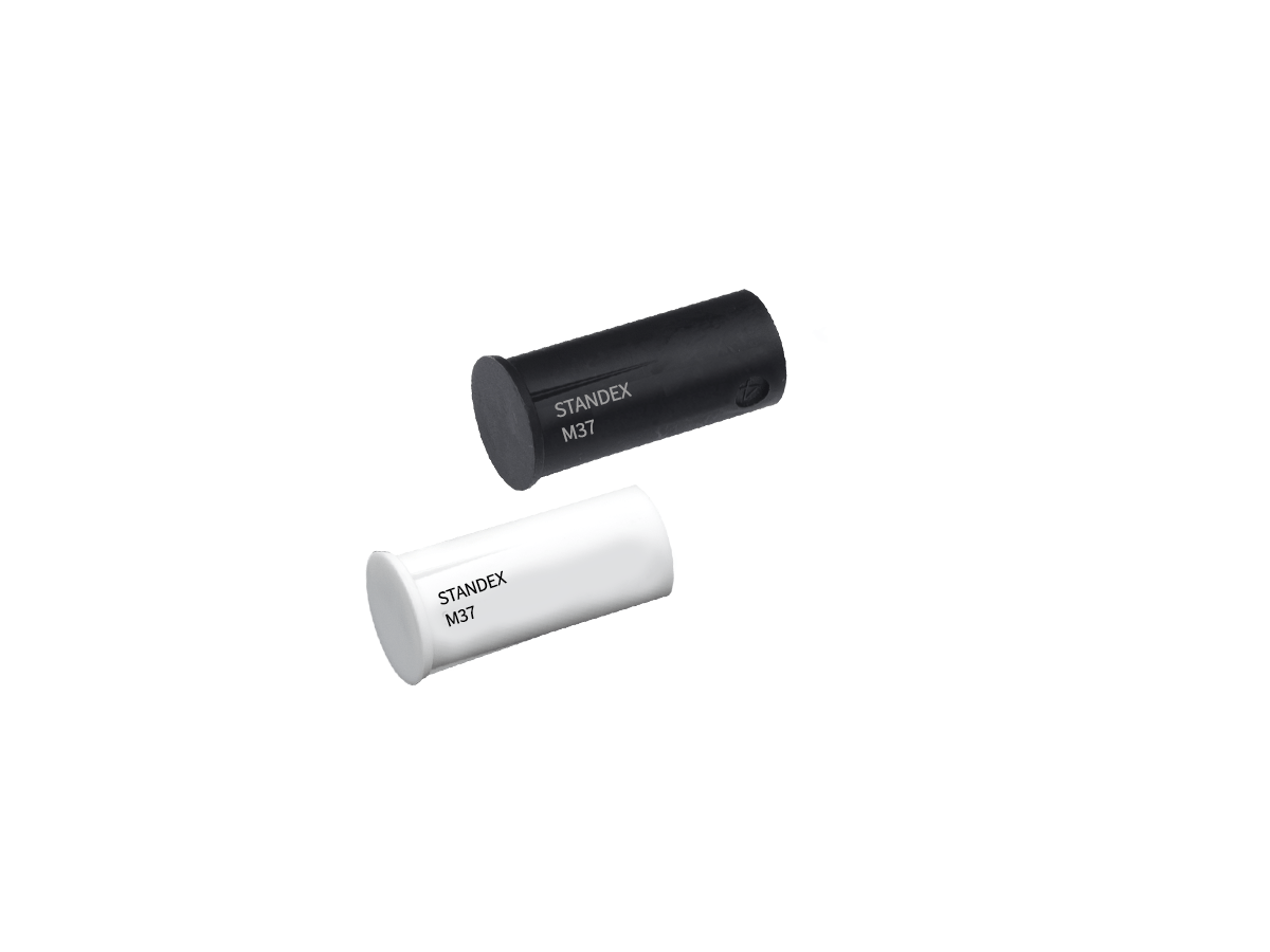 Two cylindrical objects, one black and one white, each labeled “STANDEX M3T,” from the M36 series magnet collection, are placed diagonally on a plain white background. by Standex Detect